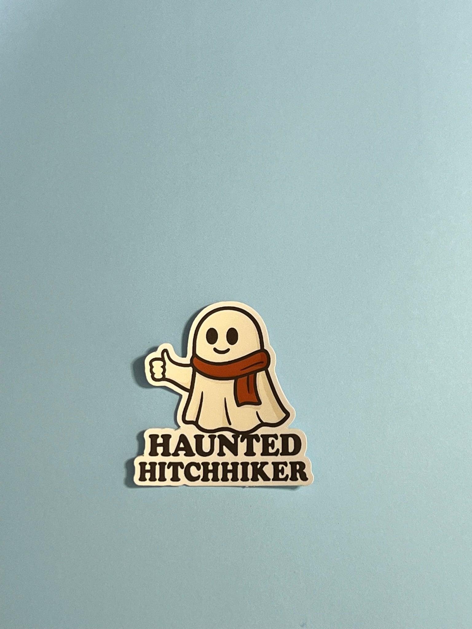 Haunted Hitchhiker Sticker – Cozy Ghost with Scarf Vinyl Sticker